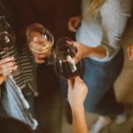 group of people tossing wine glass photo – free wi