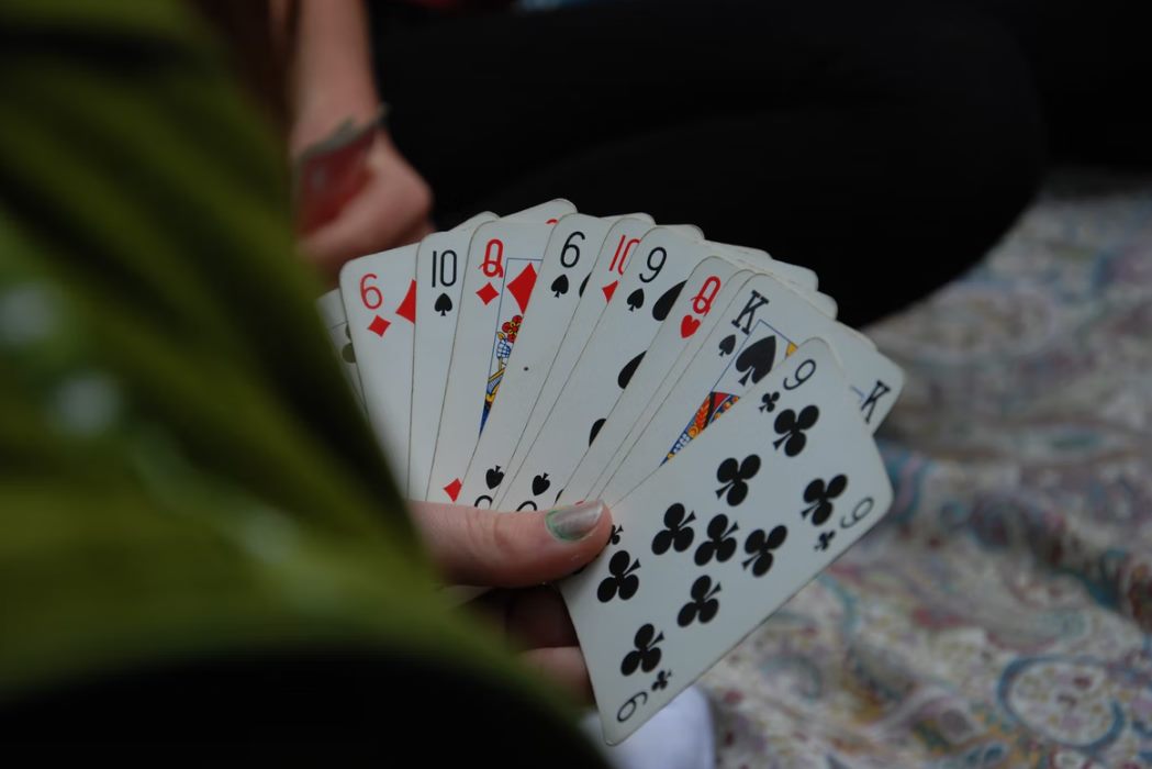person holding fan of playing cards photo – free g